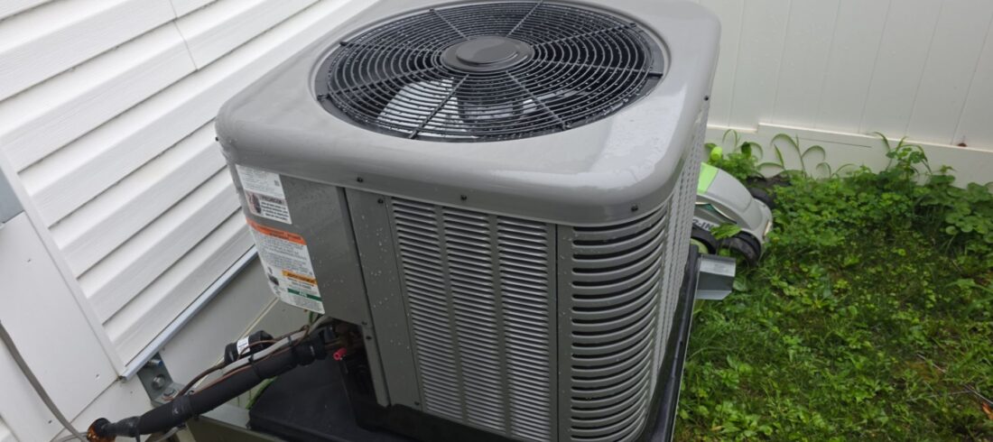 heat pump outside with white house siding